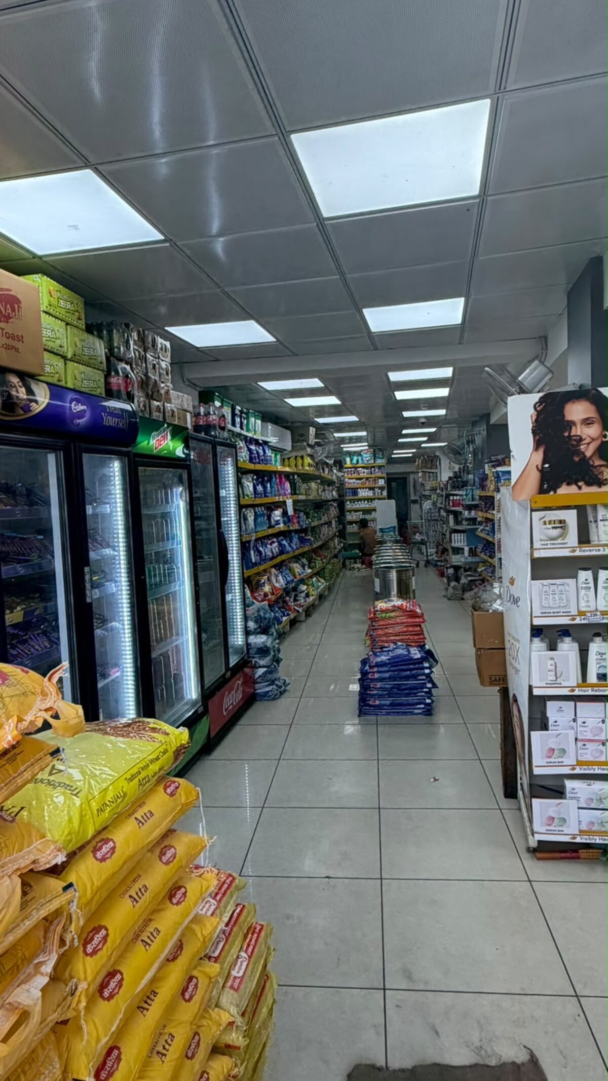 Well-stocked grocery aisle inside Ahinsa Traders showroom