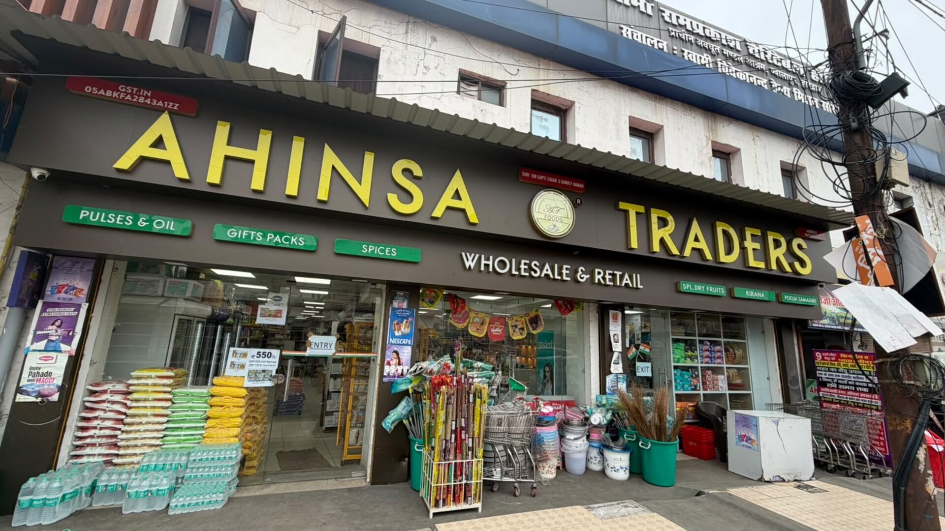 Ahinsa Traders storefront in Haridwar, with signage for pulses, oil, spices, gift packs and dry fruits